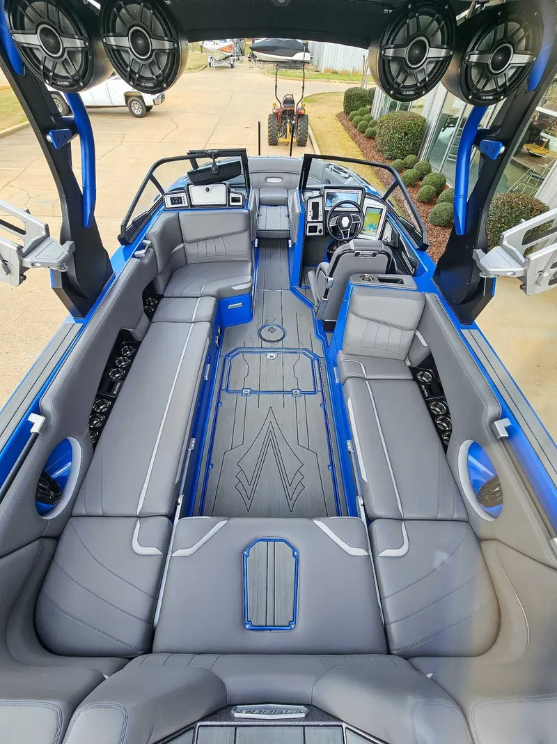 Slide: The Image of Interior view of a 2021 Supra SE 450 boat with gray seating and blue accents. - 10