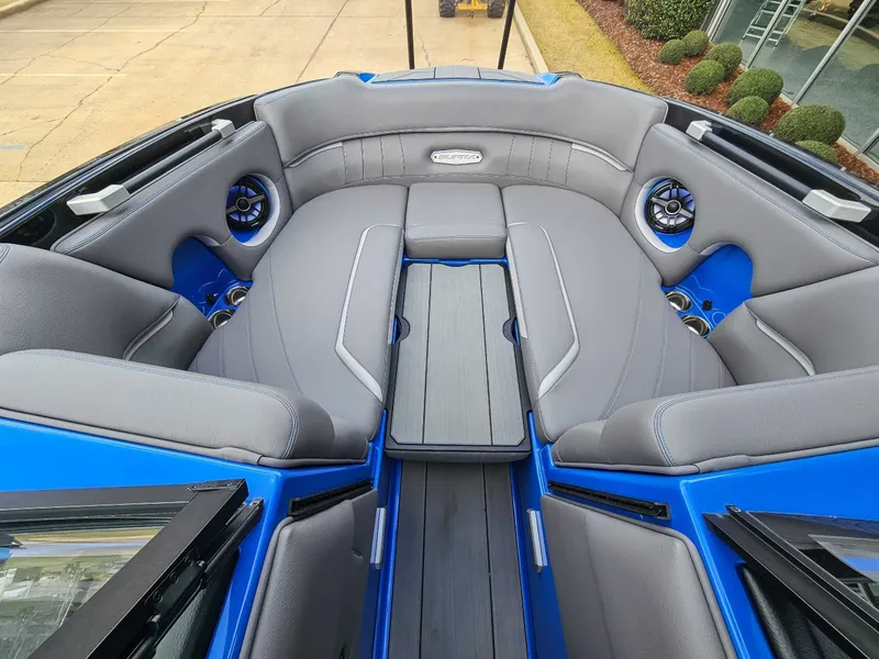 Slide: The Image of The image shows the interior of a 2021 Supra SE 450 boat with gray and blue seating. - 11