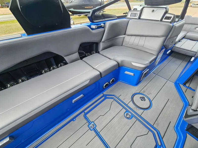 Slide: The Image of Interior of a 2021 Supra SE 450 with gray upholstery and blue accents. - 12