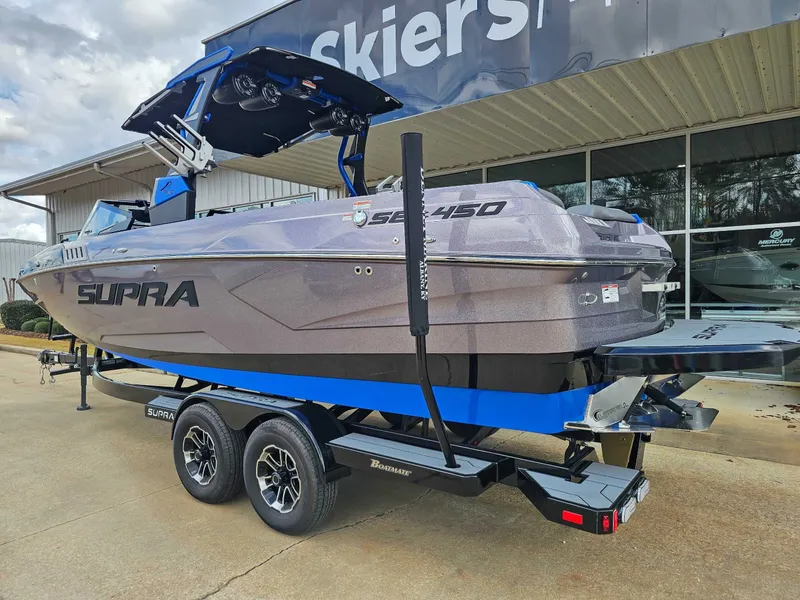 Slide: The Image of A 2021 Supra SE 450 boat on a trailer in front of a building. - 7