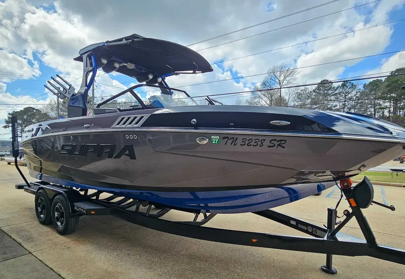 Slide: The Image of A 2021 Supra SE 450 boat on a trailer, ready for use. - 4