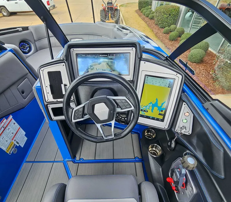 Slide: The Image of The image shows the cockpit of a 2021 Supra SE 450 boat with modern instruments. - 14