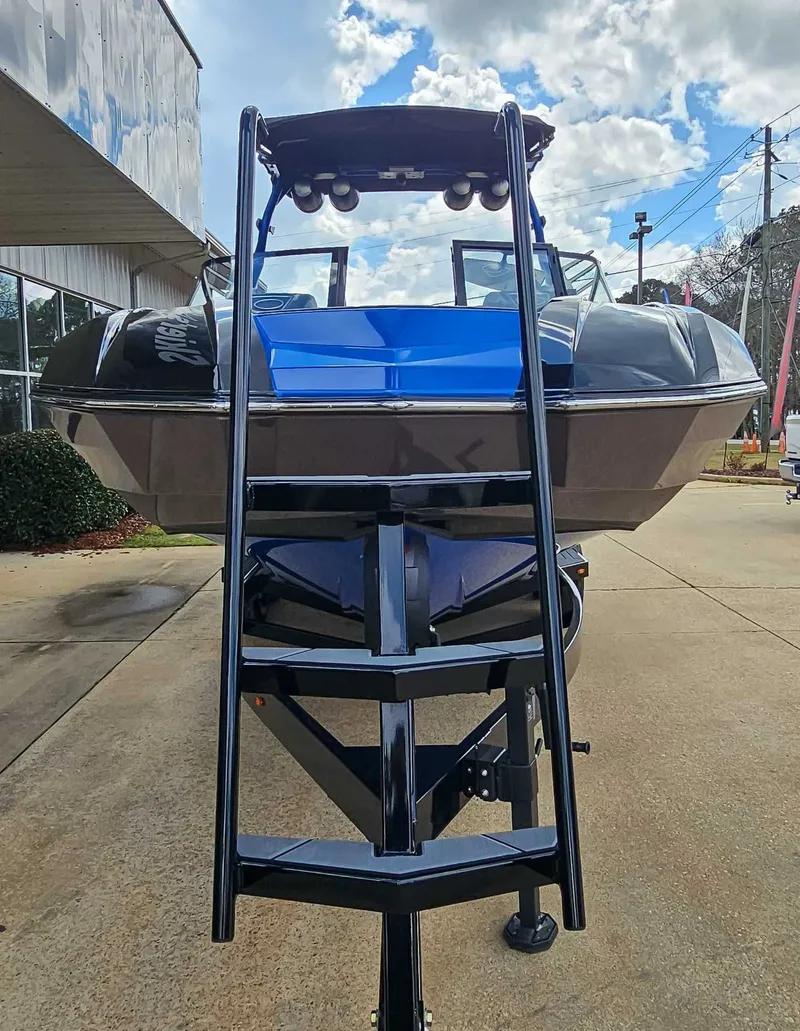 Slide: The Image of A 2021 Supra SE 450 boat on a trailer, featuring a blue and black hull. - 3