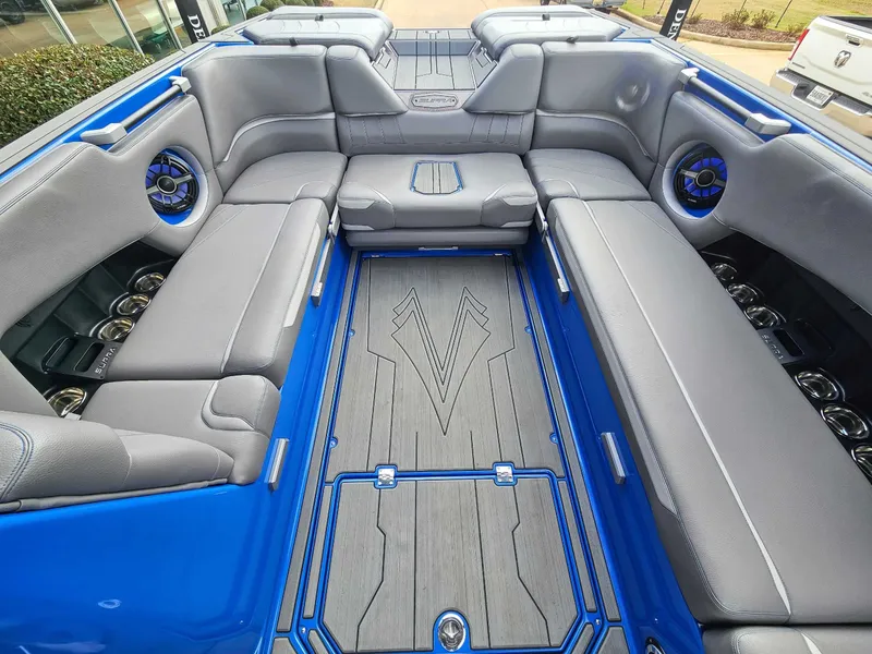 Slide: The Image of Interior of a 2021 Supra SE 450 with gray upholstery and blue accents. - 15
