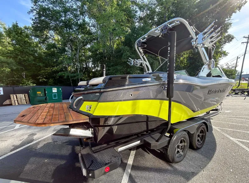 Slide: The Image of A 2020 MasterCraft XT23 on a trailer. It features a modern design with yellow accents. - 8