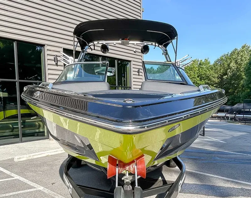 Slide: The Image of A 2020 MasterCraft XT23 boat on a trailer in front of a modern building. - 4