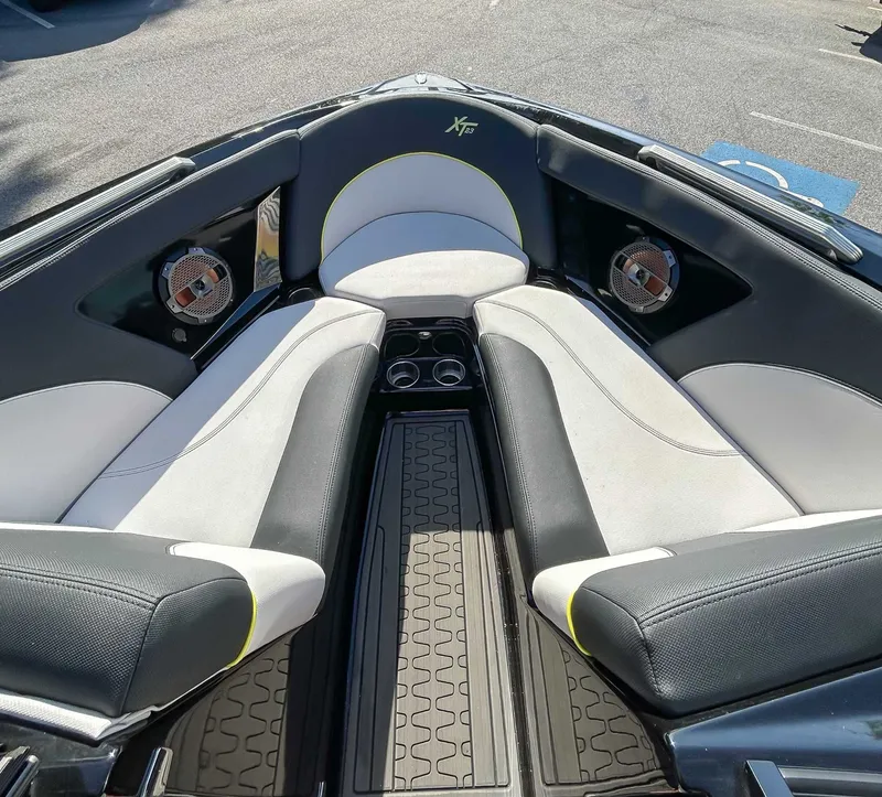 Slide: The Image of The image shows the bow area of a 2020 MasterCraft XT23 with cushioned seats and speakers. - 12