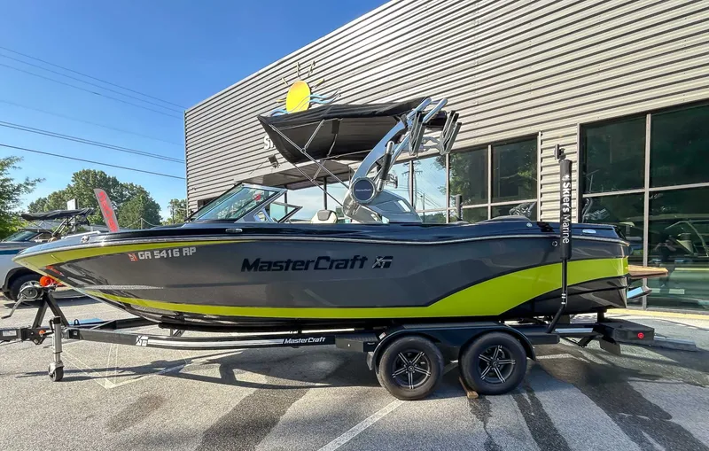 Slide: The Image of A 2020 MasterCraft XT23 boat on a trailer in front of a building. - 6