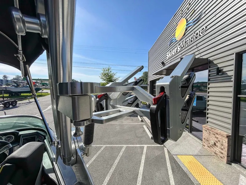 Slide: The Image of A 2020 MasterCraft XT23 is parked outside a building with a "Skiers Marine" sign. - 21