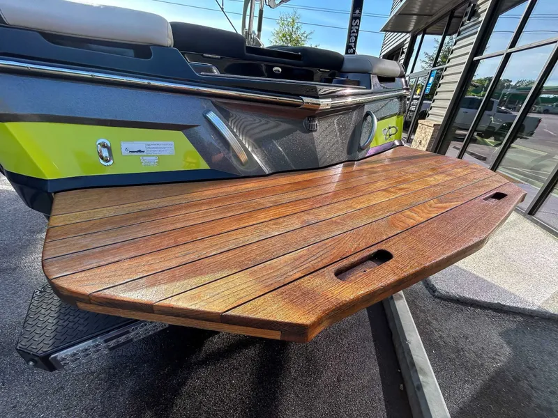 Slide: The Image of Rear of a MasterCraft XT23 boat with a wooden platform. - 7
