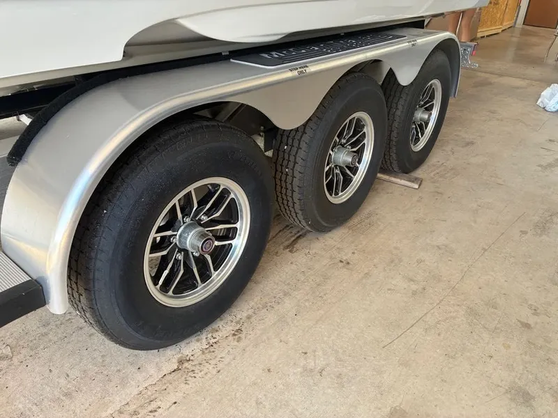 Slide: The Image of Close-up of a boat trailer with three wheels on a concrete floor. - 19