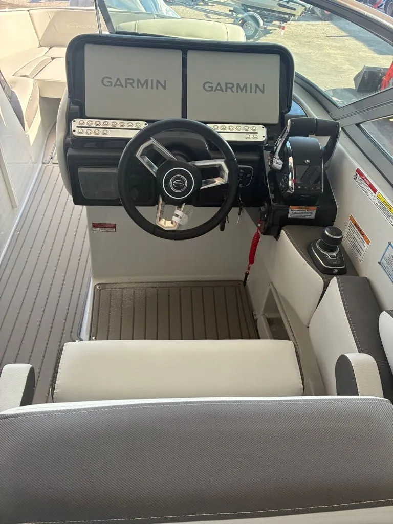 Slide: The Image of The cockpit of the 2027 Crownline 331SXSS features dual Garmin screens and a modern steering wheel. - 17