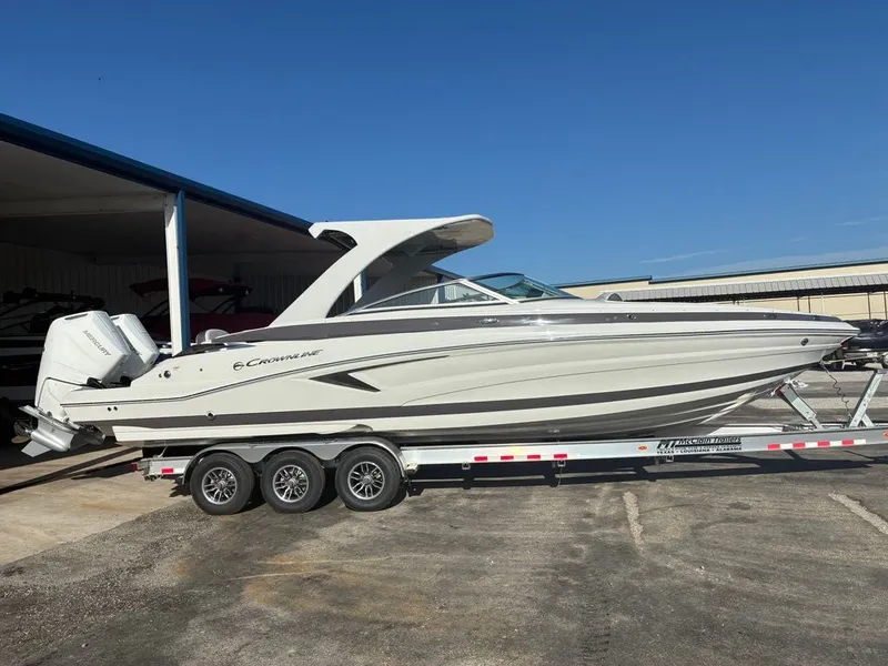 Slide: The Image of A 2027 Crownline 331SXSS boat on a trailer in a harbor area. - 5