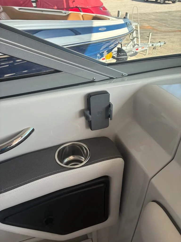 Slide: The Image of Interior view of a Crownline 331SXSS with a cup holder and phone mount. - 2