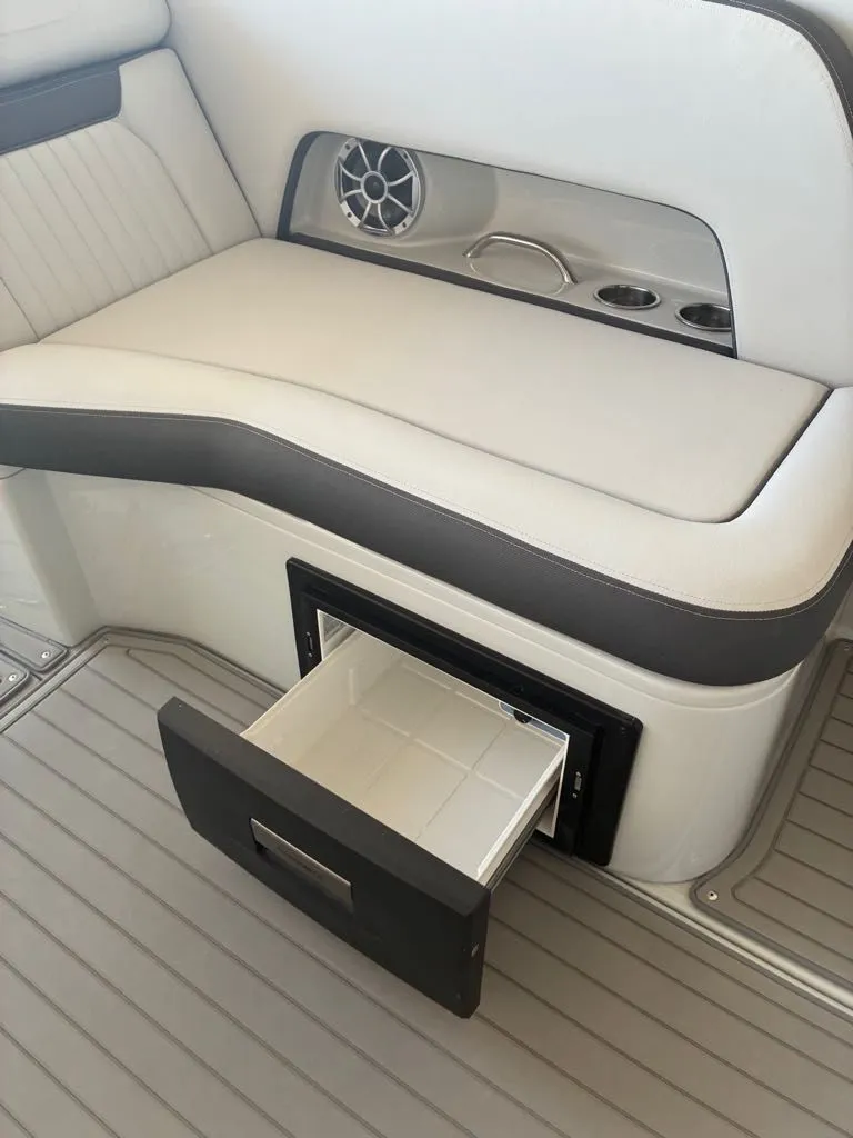 Slide: The Image of A sleek seating area with built-in speaker and cup holders. A drawer is open. - 16