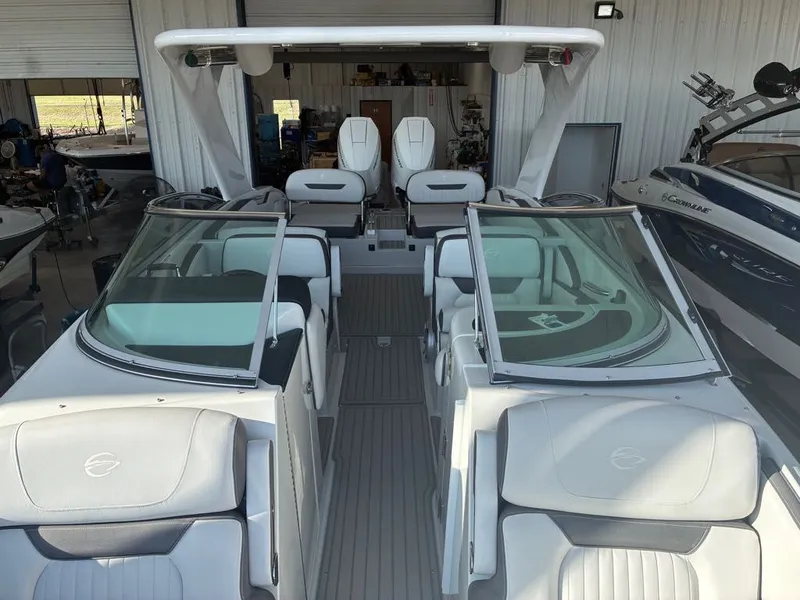 Slide: The Image of The image shows the interior of a 2027 Crownline 331SXSS boat with sleek white seating. - 18