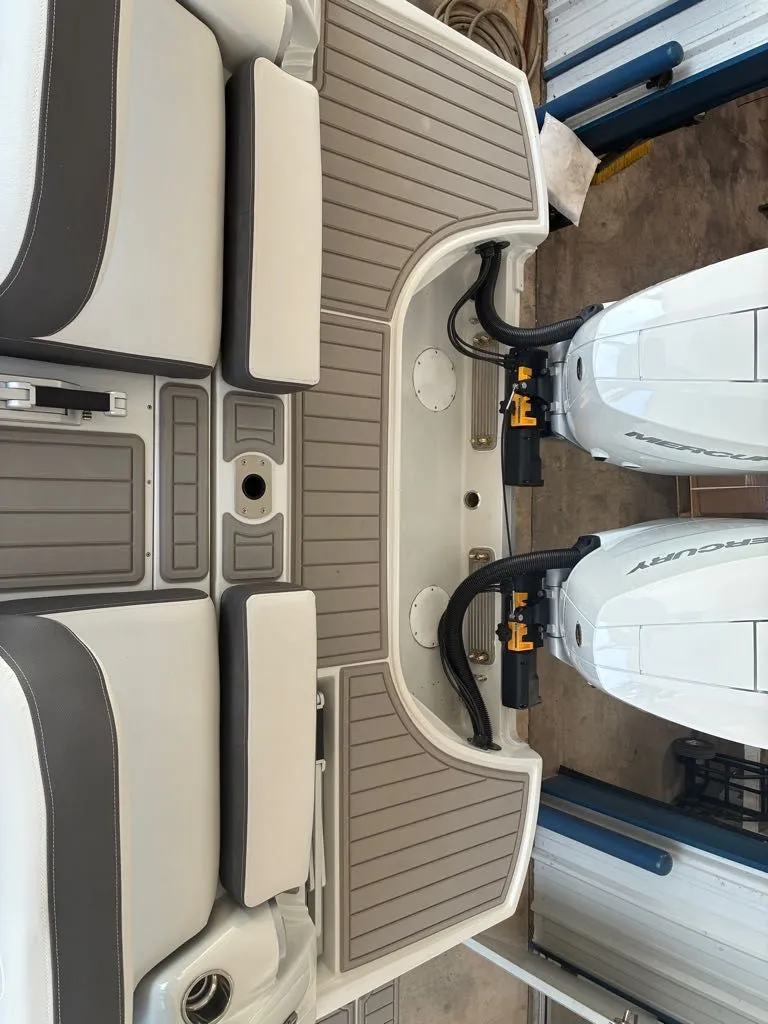 Slide: The Image of The image shows the stern of a Crownline 331SXSS with two Mercury outboard engines. - 10