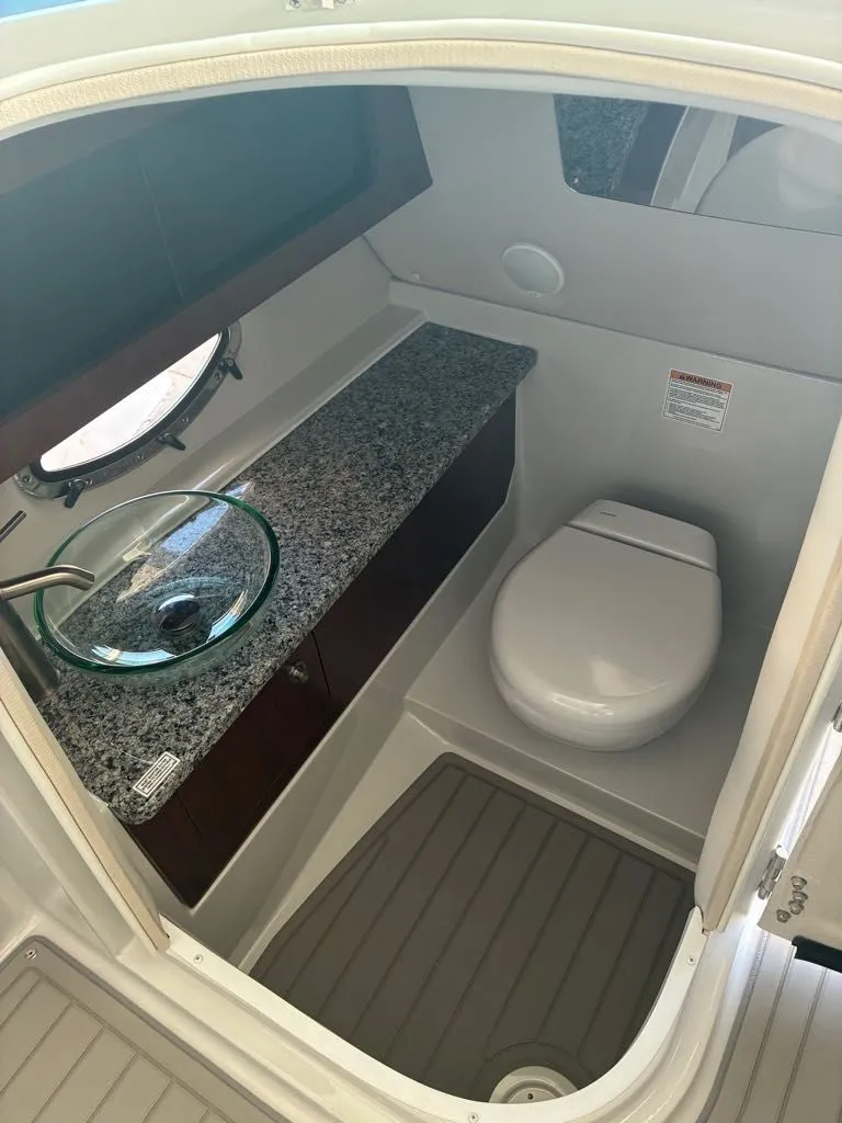 Slide: The Image of The image shows a modern boat bathroom with a toilet and a sink. - 9