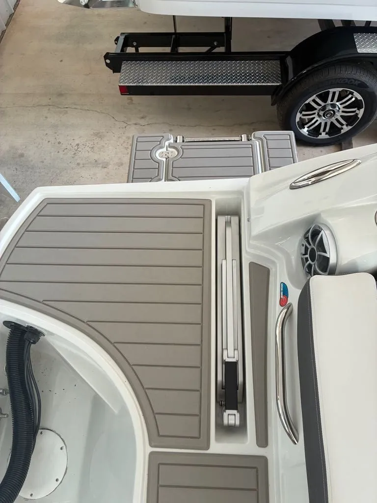 Slide: The Image of The image shows the deck of a 2027 Crownline 331SXSS boat with gray and white details. - 11