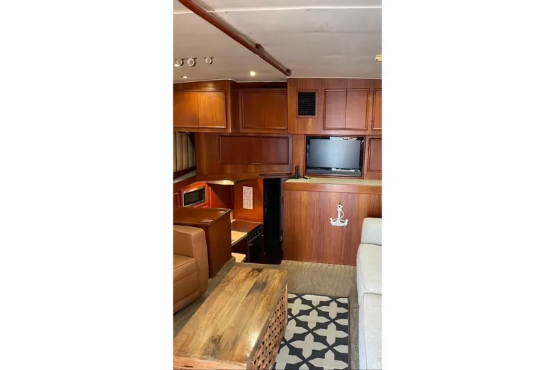 Slide: The Image of Interior of 1987 Post 43 Convertible yacht with wood cabinetry and cozy seating area. - 20