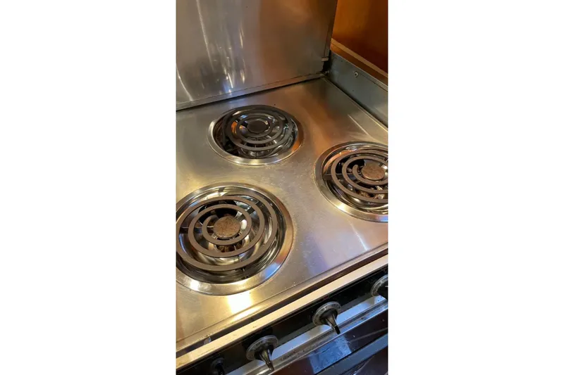 Slide: The Image of Stainless steel electric stove with three coil burners, vintage design. - 16