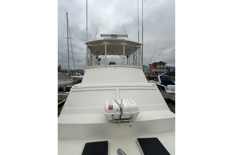 Slide: The Image of 1987 Post 43 Convertible yacht docked at marina under cloudy skies. - 8