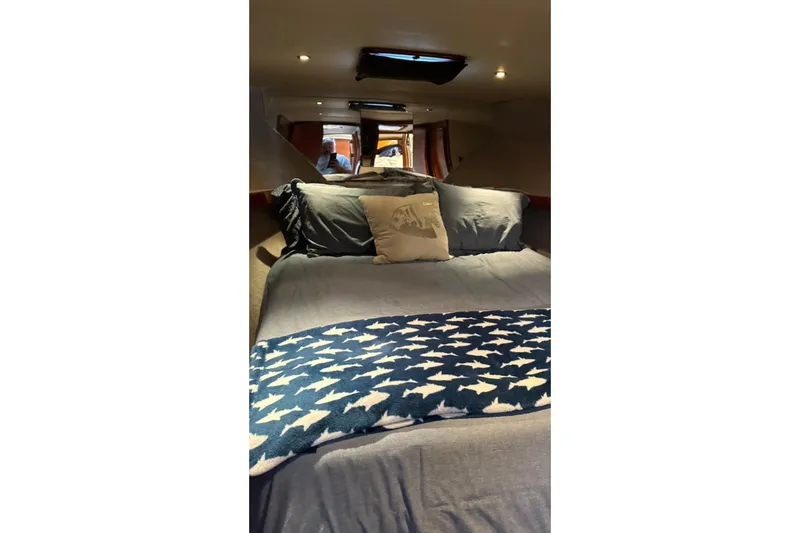 Slide: The Image of Interior cabin of a 1987 Post 43 Convertible yacht with cozy bedding and decor. - 18