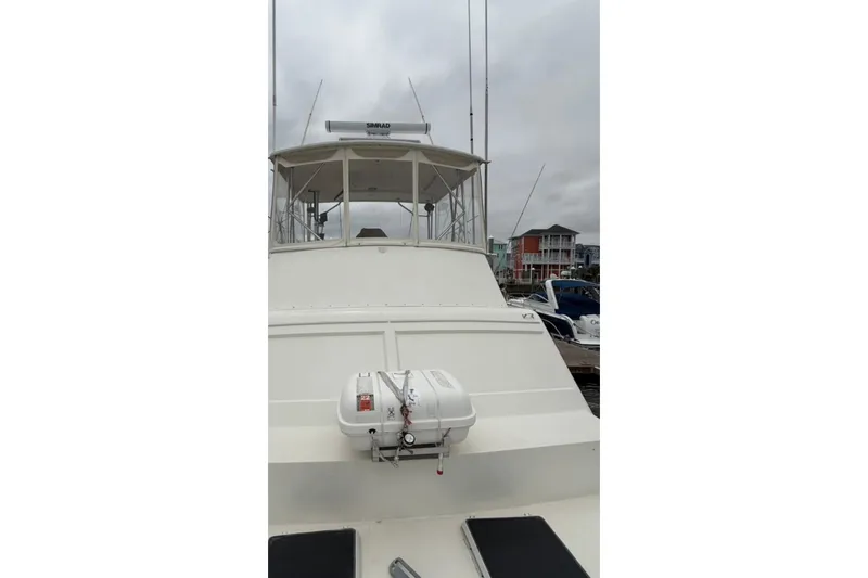 Slide: The Image of 1987 Post 43 Convertible yacht docked, featuring radar and life raft on deck. - 10