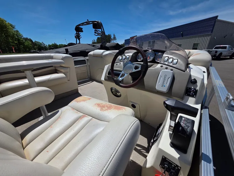 Slide: The Image of Interior view of a 2008 Bennington 2275RL SPS TRI with beige leather and steering console. - 4