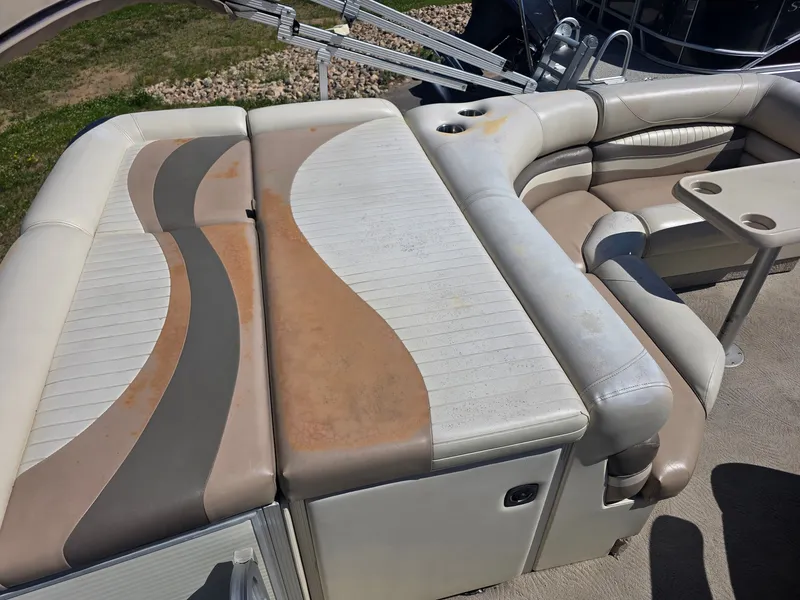Slide: The Image of The image shows the seating area of a 2008 Bennington 2275RL SPS TRI with worn upholstery. - 18