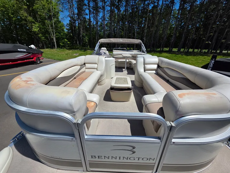 Slide: The Image of A 2008 Bennington pontoon boat with spacious seating and a central table. - 2