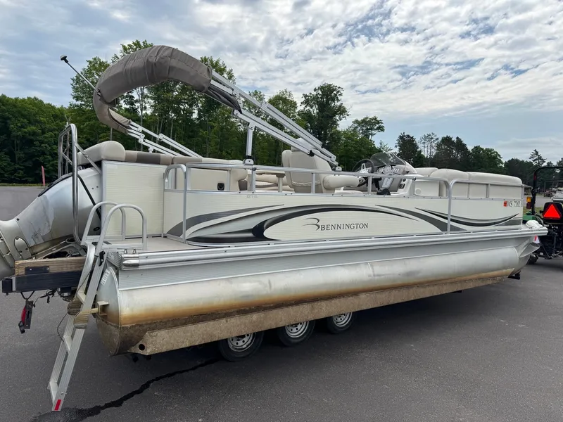 Slide: The Image of A 2008 Bennington 2275RL SPS TRI pontoon boat on a trailer, surrounded by trees. - 8