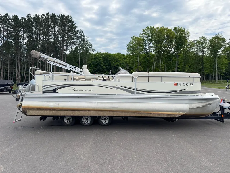 Slide: The Image of A 2008 Bennington 2275RL SPS TRI pontoon boat on a trailer, surrounded by trees. - 5