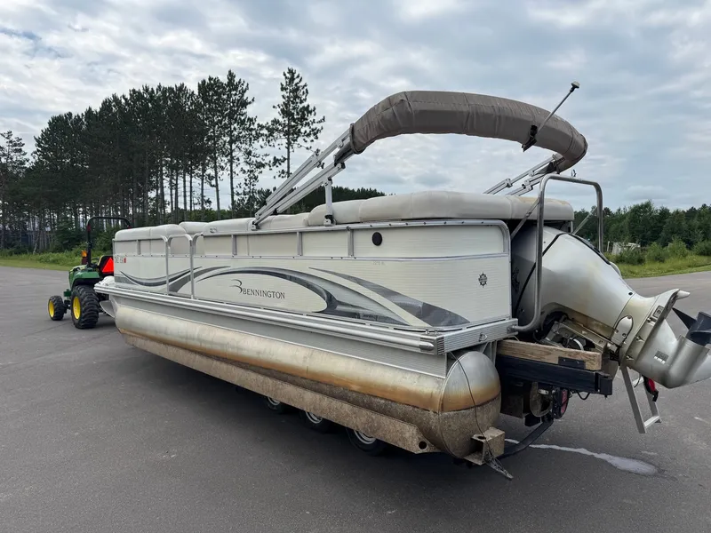 Slide: The Image of A 2008 Bennington 2275RL SPS TRI pontoon boat on a trailer, set against a forest backdrop. - 7