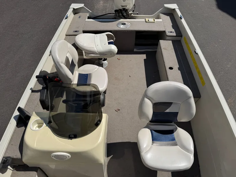 Slide: The Image of The image shows a boat with two seats and a helm. It is on solid ground. - 12