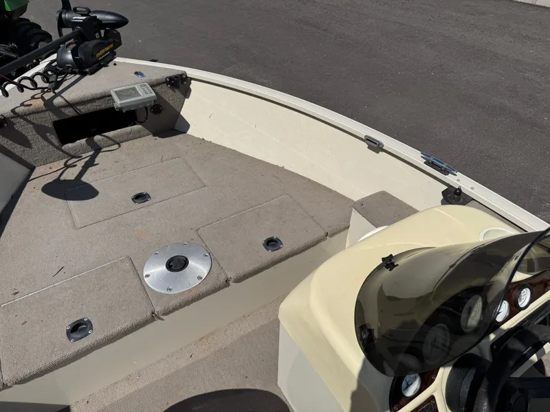 Slide: The Image of The image shows the deck of a 2002 Misty Harbor 166C Trophy boat with console and seating. - 14