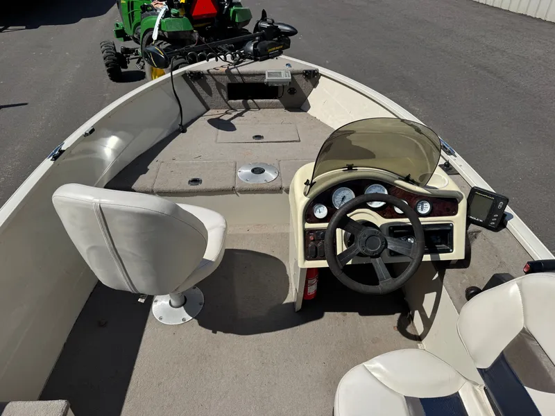 Slide: The Image of The image shows a boat cockpit with a steering console and two seats. - 9