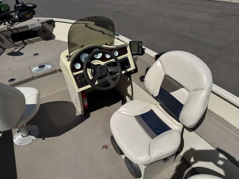 Slide: The Image of The image shows the cockpit of a 2002 Misty Harbor 166C Trophy boat with a helm and seat. - 18
