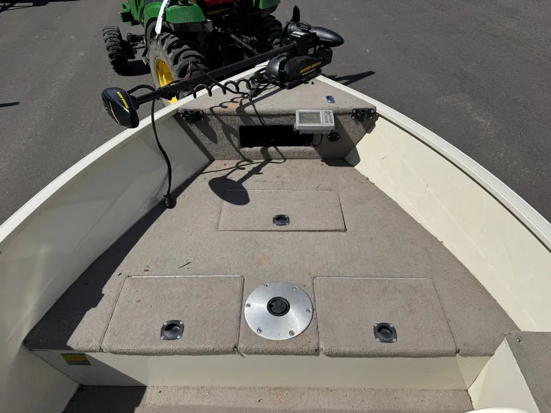 Slide: The Image of The boat features an open bow area with gray carpeting and a control device. - 10