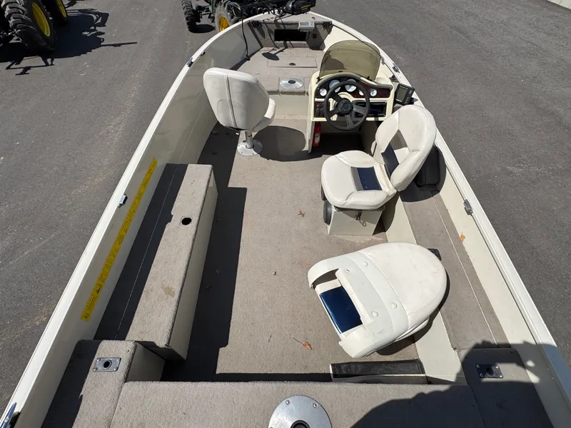 Slide: The Image of The image shows the interior of a 2002 Misty Harbor 166C Trophy boat with several seats. - 8