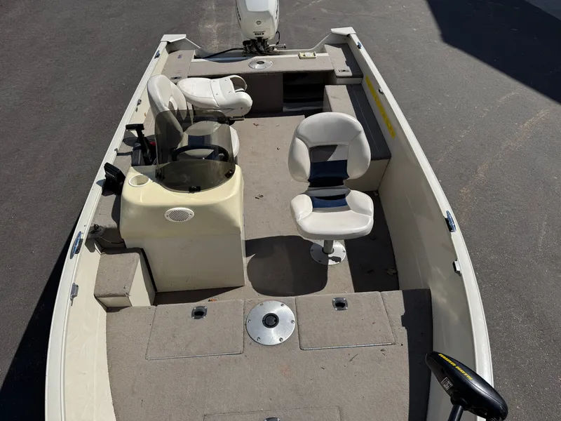 Slide: The Image of The image shows a 2002 Misty Harbor 166C Trophy boat with multiple seats and a helm station. - 11