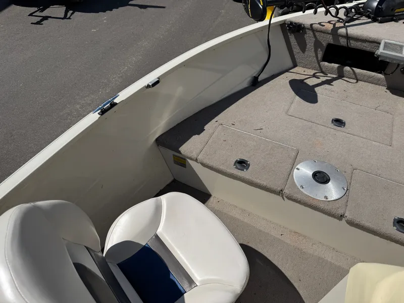 Slide: The Image of The image shows the interior of a boat with a seat and gray carpeted flooring. - 15
