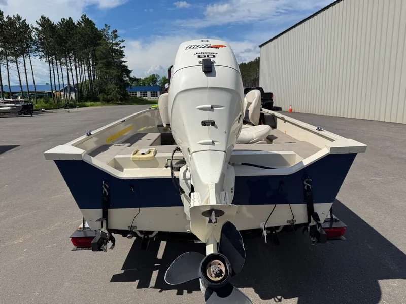 Slide: The Image of A 2002 Misty Harbor 166C Trophy boat with an outboard motor on a trailer. - 7