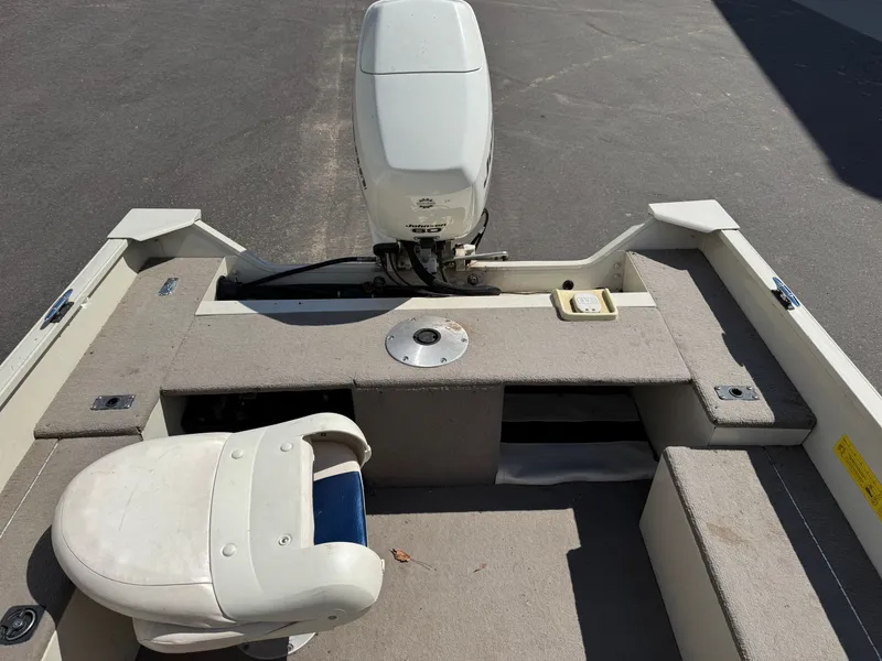 Slide: The Image of The image shows the stern of a boat with an outboard motor and seating area. - 13