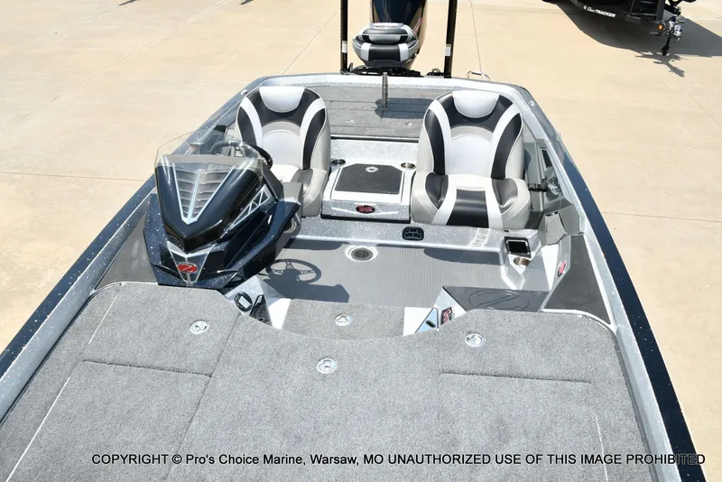 Slide: The Image of The image shows a modern 2021 Ranger Z521L CUP boat with gray seats and carpeted flooring. - 17
