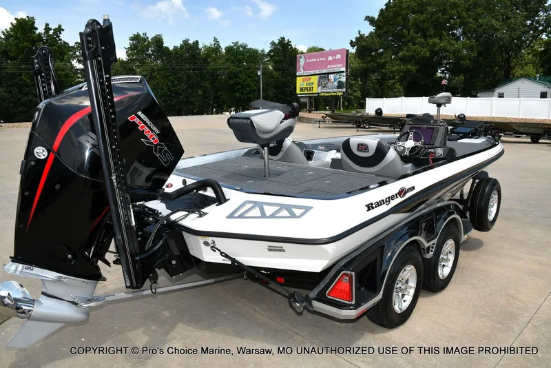 Slide: The Image of A 2021 Ranger Z521L CUP boat on a trailer in a parking lot. - 24