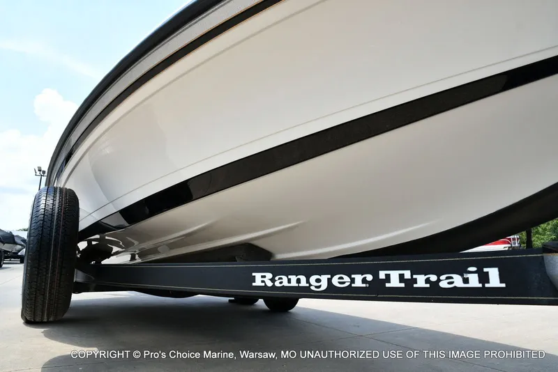 Slide: The Image of Close-up of a boat trailer labeled "Ranger Trail." The boat is white and black. - 39