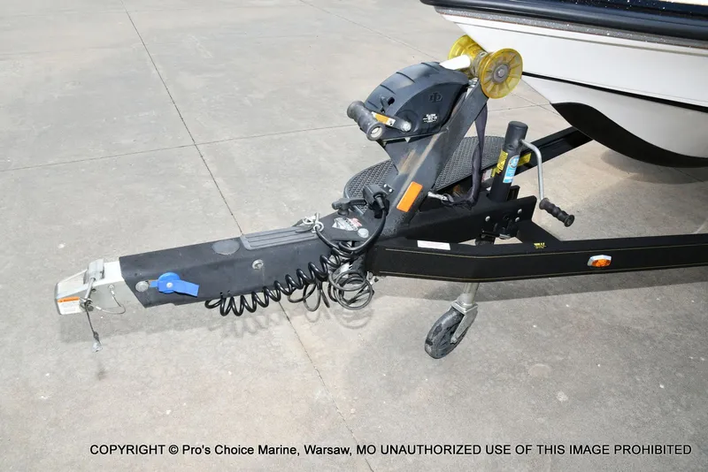 Slide: The Image of Close-up of a boat trailer with hitch and jack wheel on a concrete surface. - 37