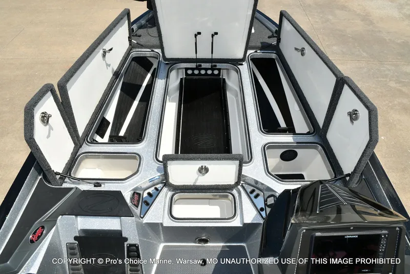 Slide: The Image of The image shows the deck of a Ranger Z521L CUP boat with multiple open storage compartments. - 13