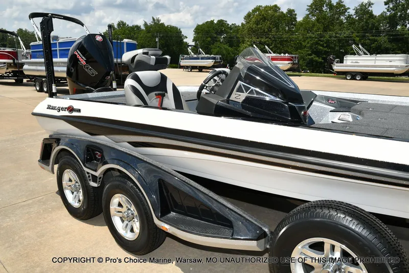 Slide: The Image of A 2021 Ranger Z521L CUP boat on a trailer, featuring a powerful outboard motor. - 27